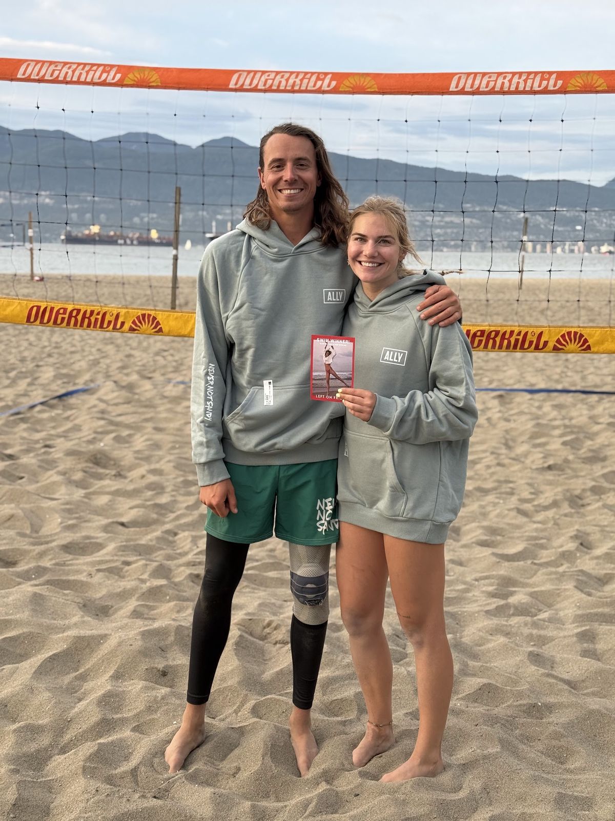 Two players at Spanish Banks wearing the ALLY x NNS Do The Kind Thing Hoodie