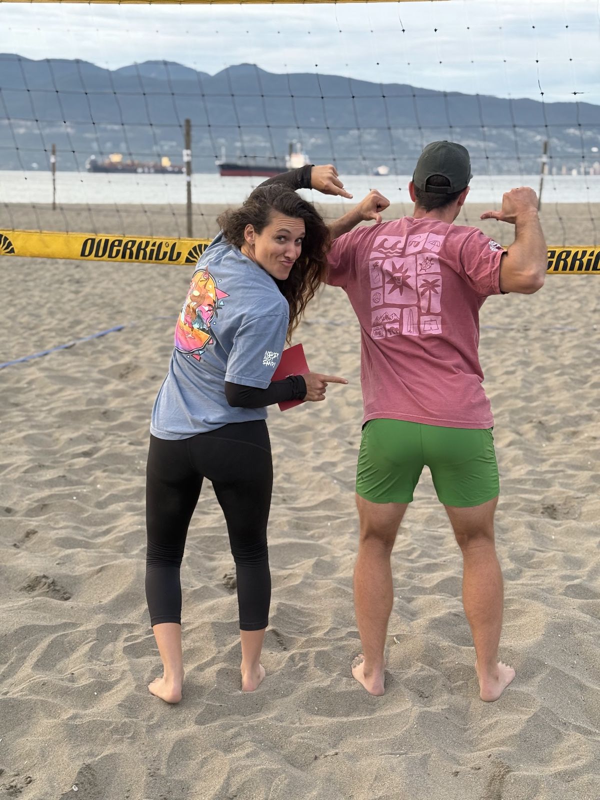 Player at Spanish Banks pointing at the Chicken Joe graphic on the back of her tee