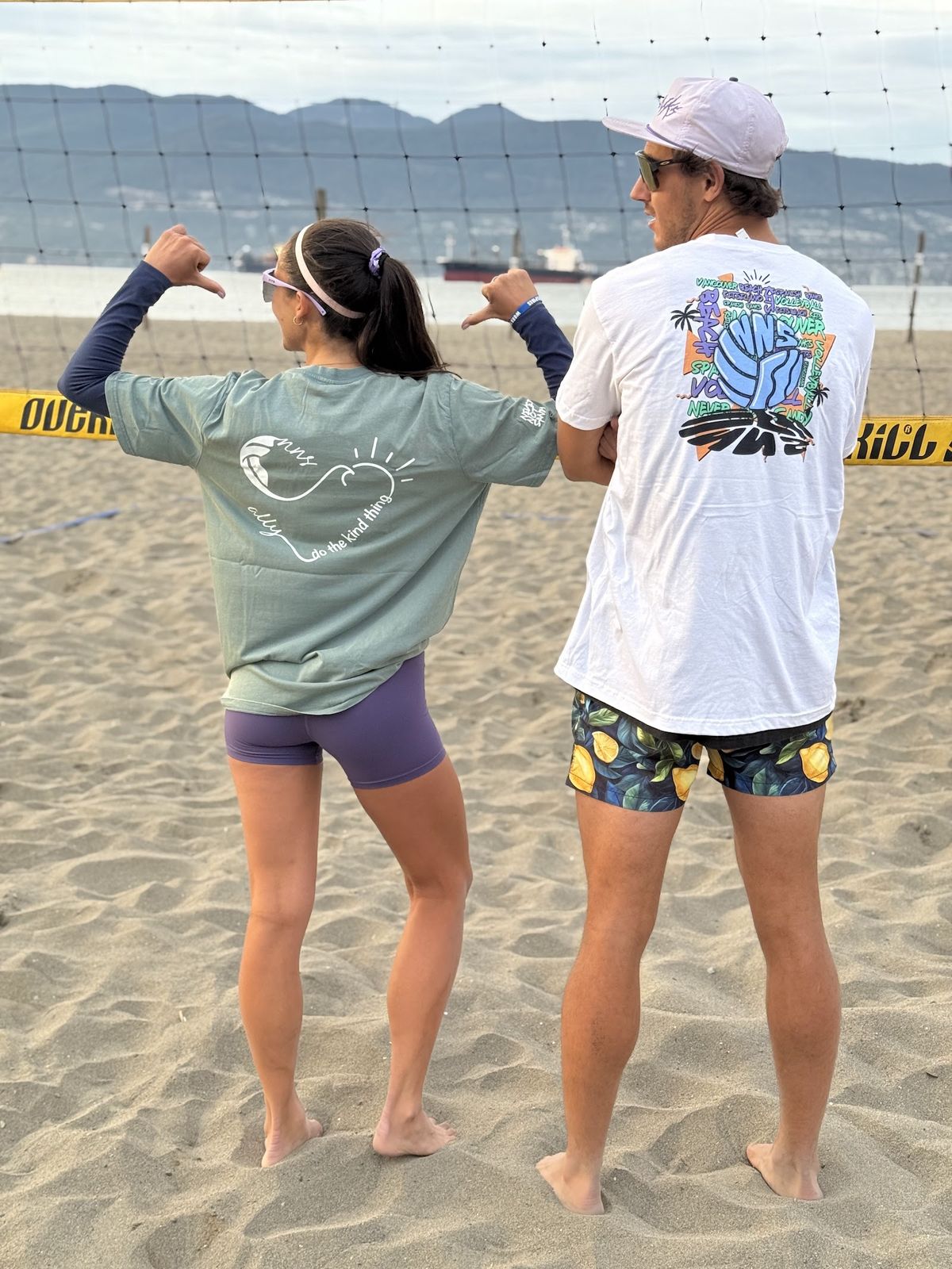 Player in a white Local Courts Tee showing the volleyball graphic on the back