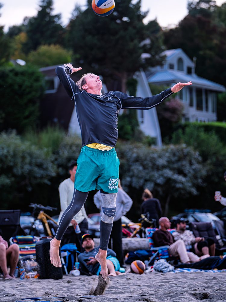 Player leaping at the net in teal shorts