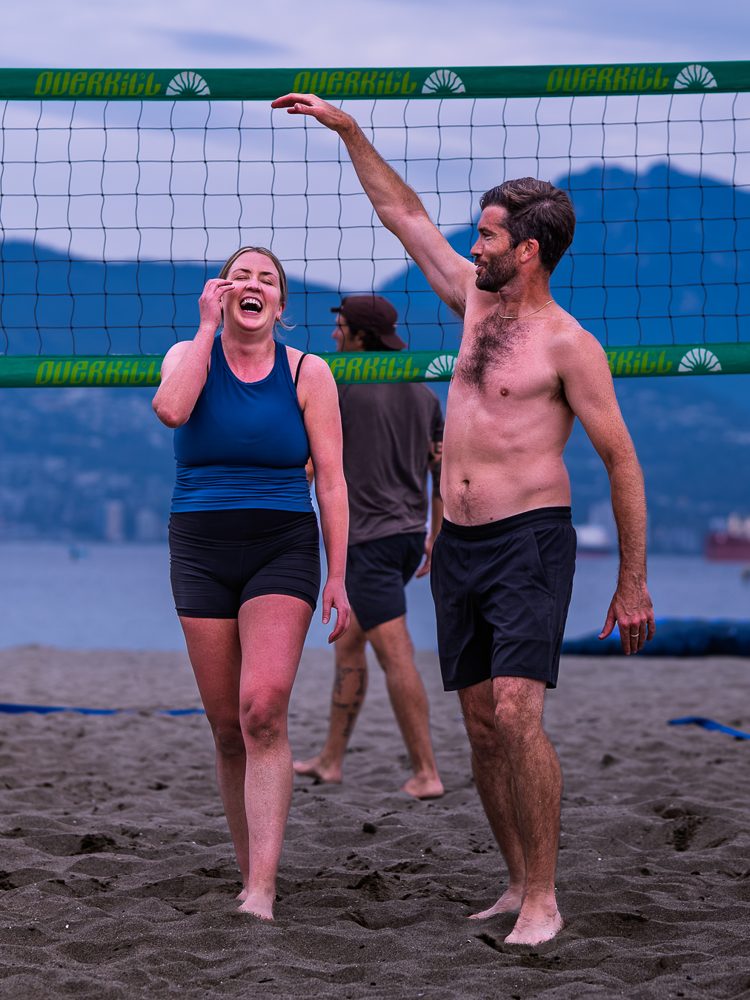 Teammates cracking up at the net