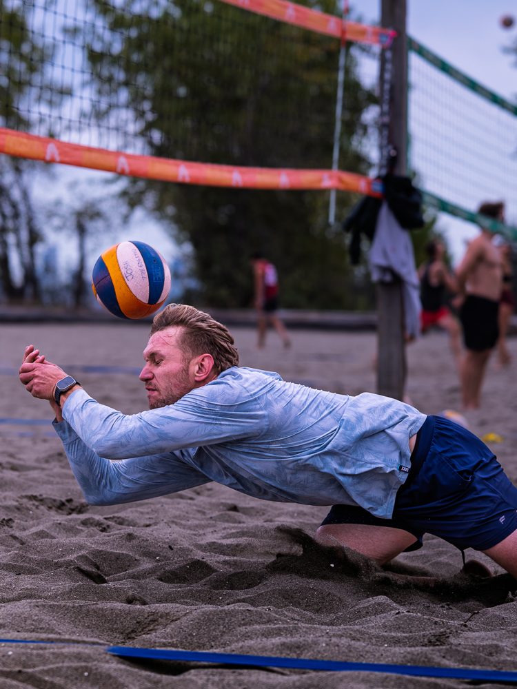 Player sprawling for a dig in the sand