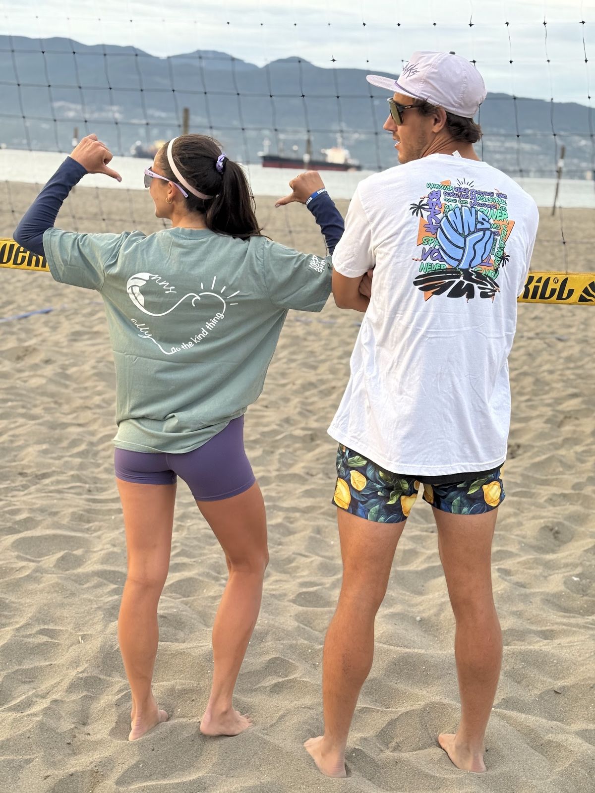 Player at Spanish Banks showing the ALLY x NNS heart print on the back of a sage tee