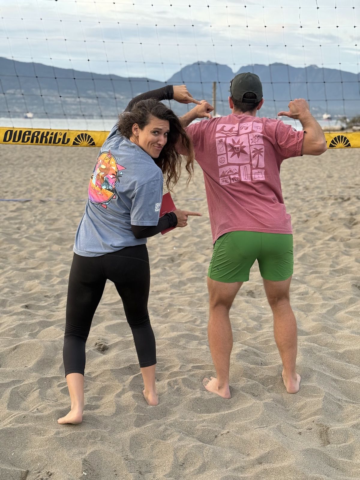 Player flexing to show the Beach Tiles print on the back of a red tee